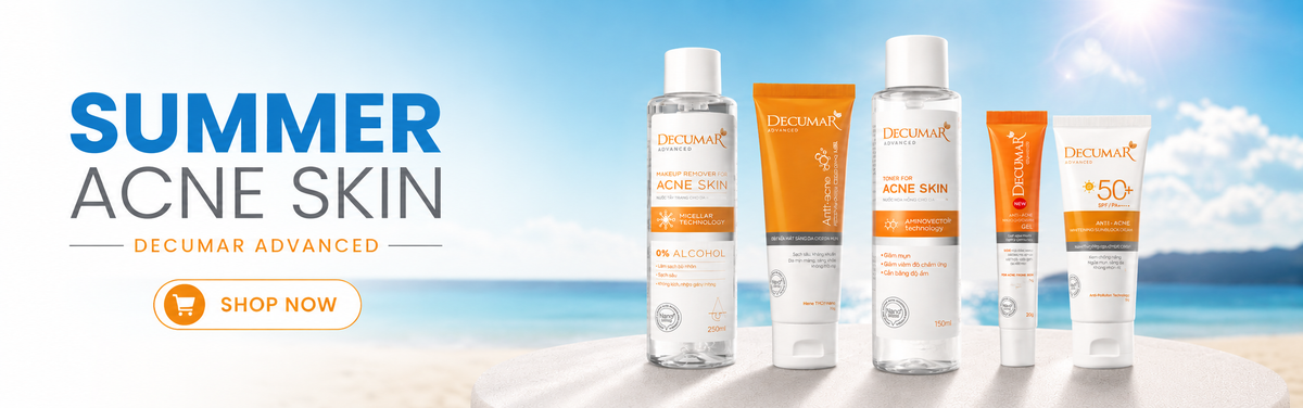 A promotional banner for Decumar Advanced Summer Acne Skin products, showing a lineup of skincare bottles and tubes with orange and white labels, set against a beach background with blue sky and ocean.
